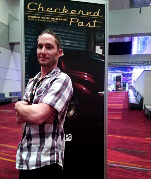 Jason Killmer stands in front of the banner (at SEMA 2013) of the 2013 Ridler Award Winner "Checkered Past" which he Wet Sanded & Polished. Jason Killmer - 2013 Ridler Award Winner "Checkered Past" - Wet Sanding & Buffing - Color Sanding - world class wet sanding instructor .