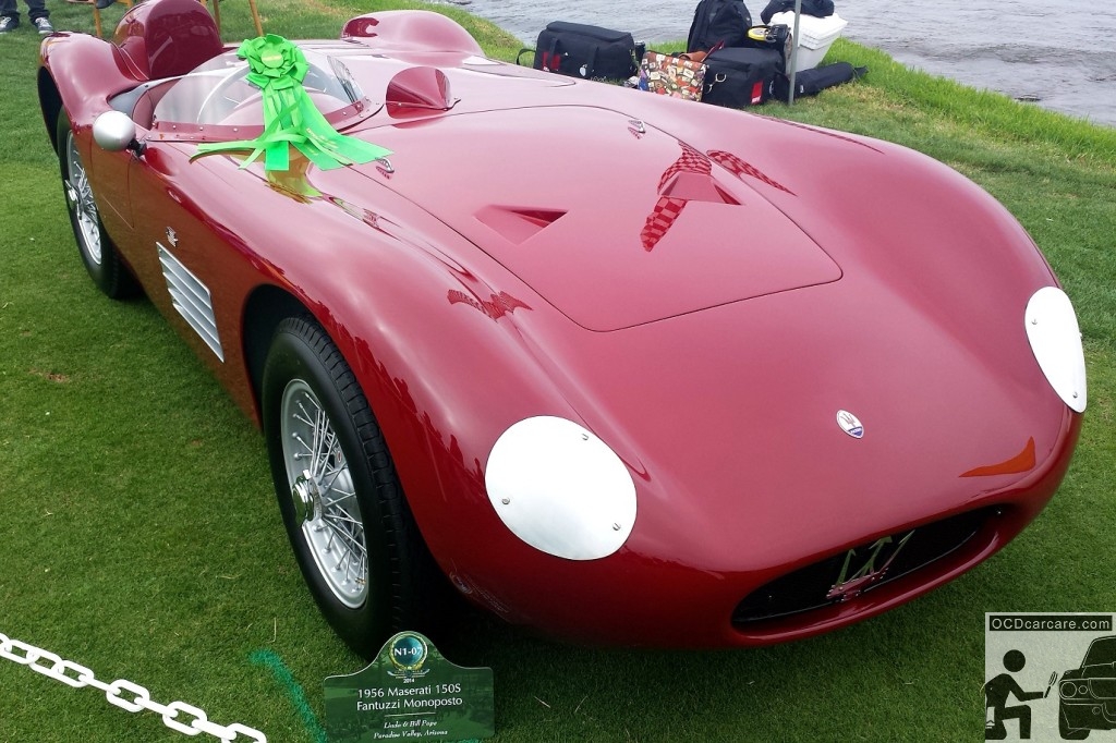 1956 Maserati 150S - displaying its sultry burgandy color against the backdrop of the 18th hole at the 2014 Pebble Beach Concours d' Elegance 1956 Maserati 150S on 18th hole at the 2014 Pebble Beach Concours d' Elegance
