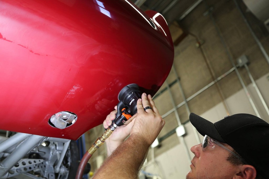 Scott Nichols of Distinct Detail color sands the bottom portion of the rear bumper to even the texture of the paint on this 1956 Maserati 150S. Scott Nichols of Distinct Detail color sands the bottom portion of the rear bumper to even the texture of the paint on this 1956 Maserati 150S.