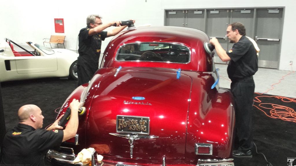 OCDCarCare at SEMA 2013 - Derek Bemiss, Jason Rose, & Kevin Brown final polish a 1940 Oldsmobile in the House of Kolors booth.