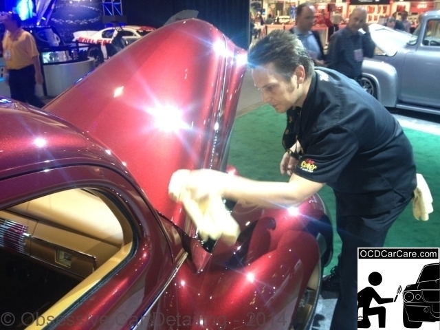 OCDCarCare SEMA 2013 - Christopher Brown, of OCDCarCare, gently wiping down the 2013 Rdiler Award winner "Checkerd Past."